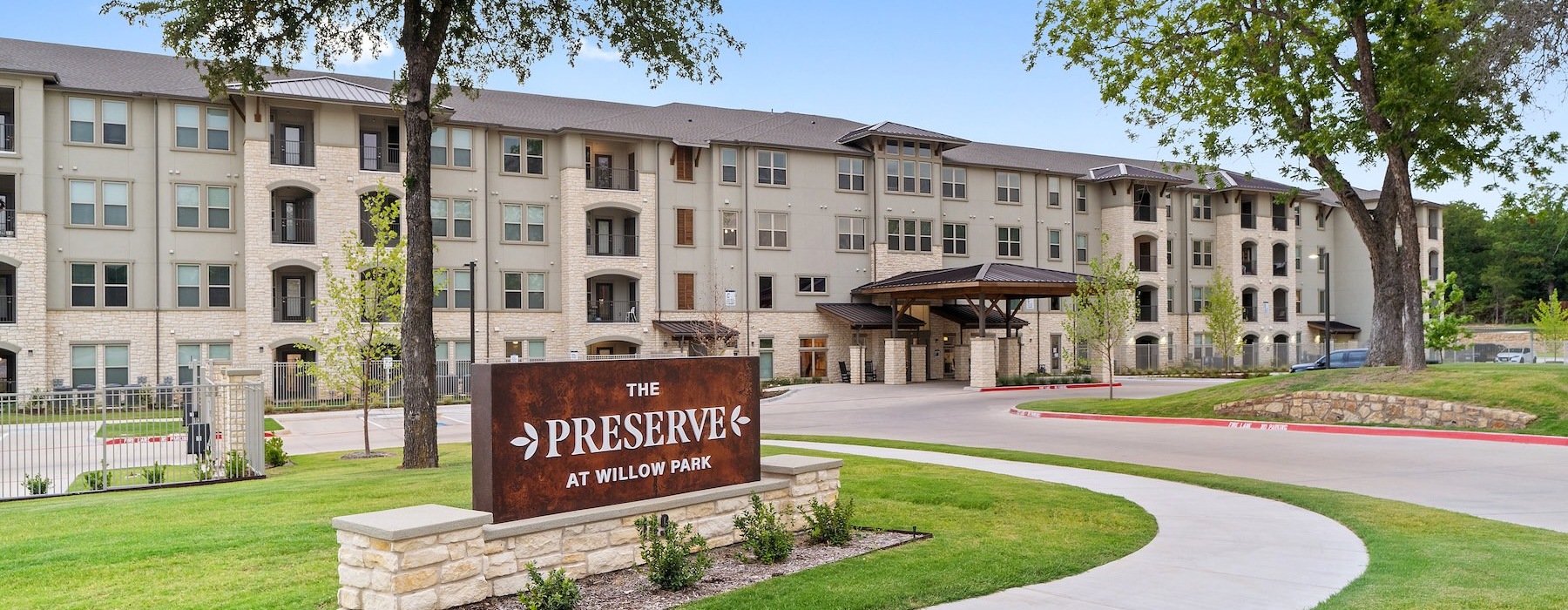a sign in front of a building that's reads the preserve at willow park