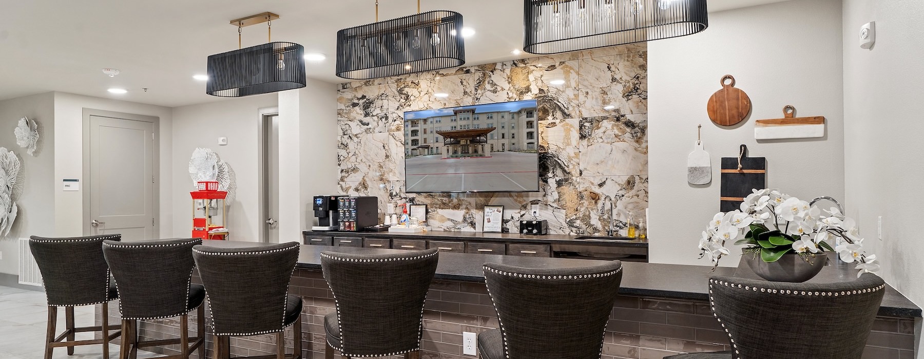 a room with a bar and chairs