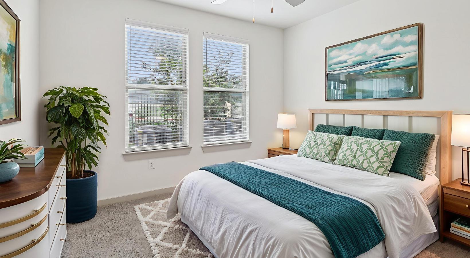 Bedroom options to fit every lifestyle a bedroom with a bed and a fan and windows