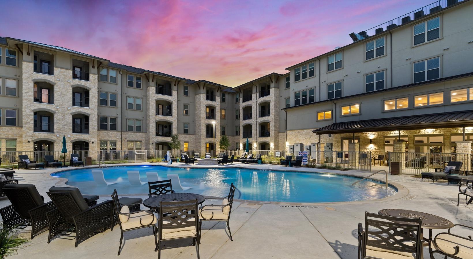 Relax and unwind poolside a pool in a courtyard