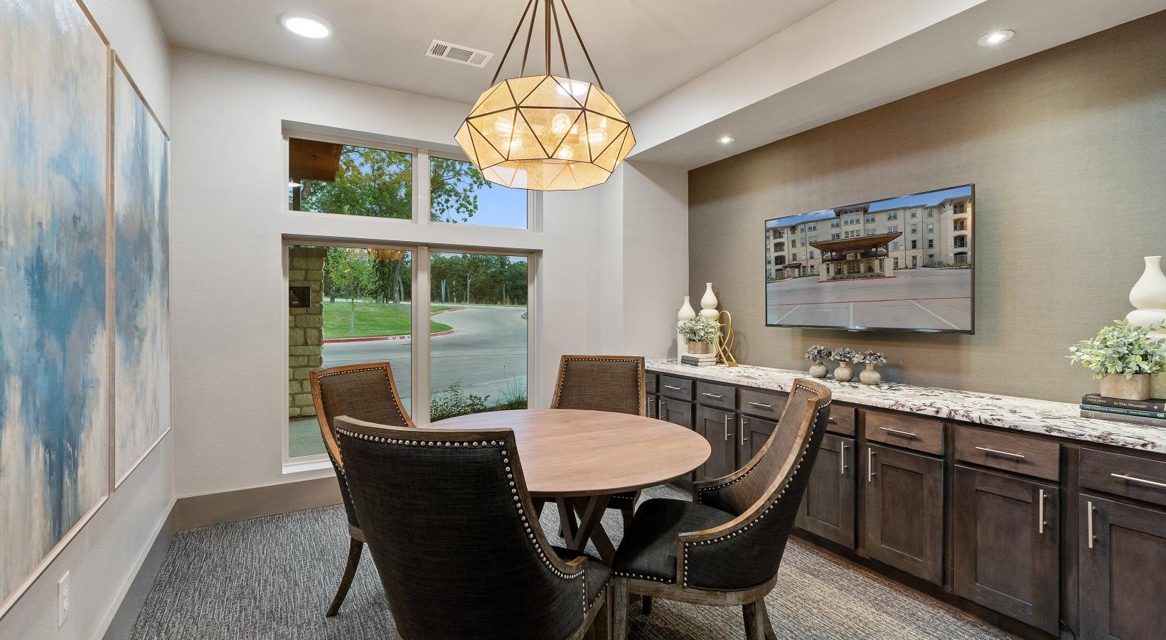 Settle into comfort at Preserve at Willow Park a work room with a chandelier and a table with seating