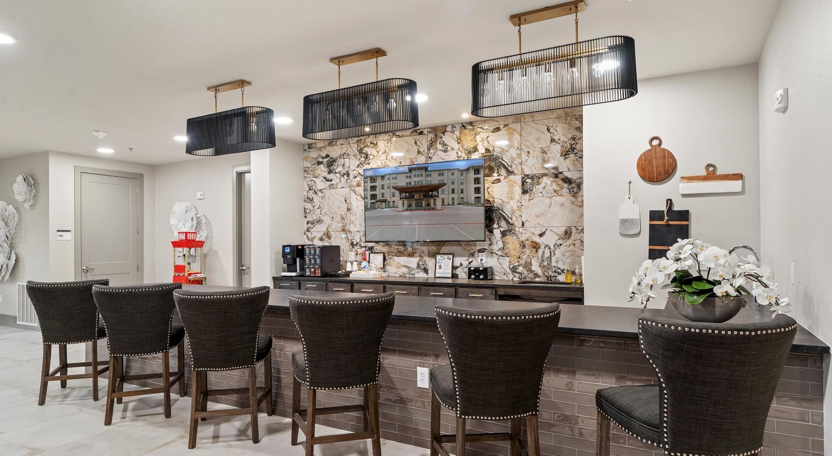 Everything within reach a room with a bar and chairs