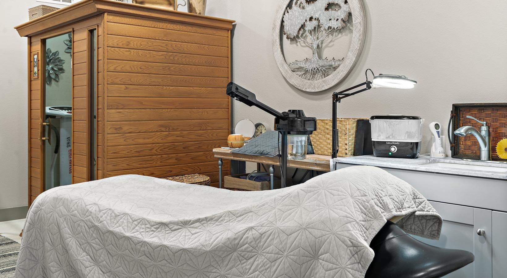 Access to resident-only features a spa room with a spa bed and a desk