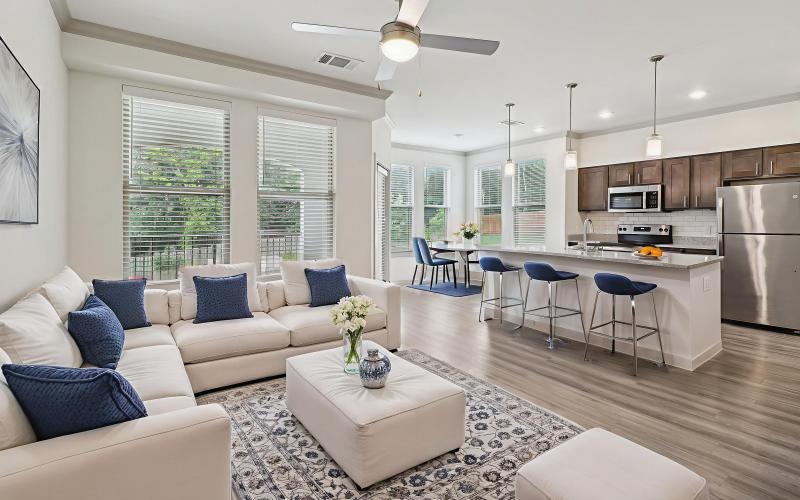 a large living room with a large kitchen and a large windows