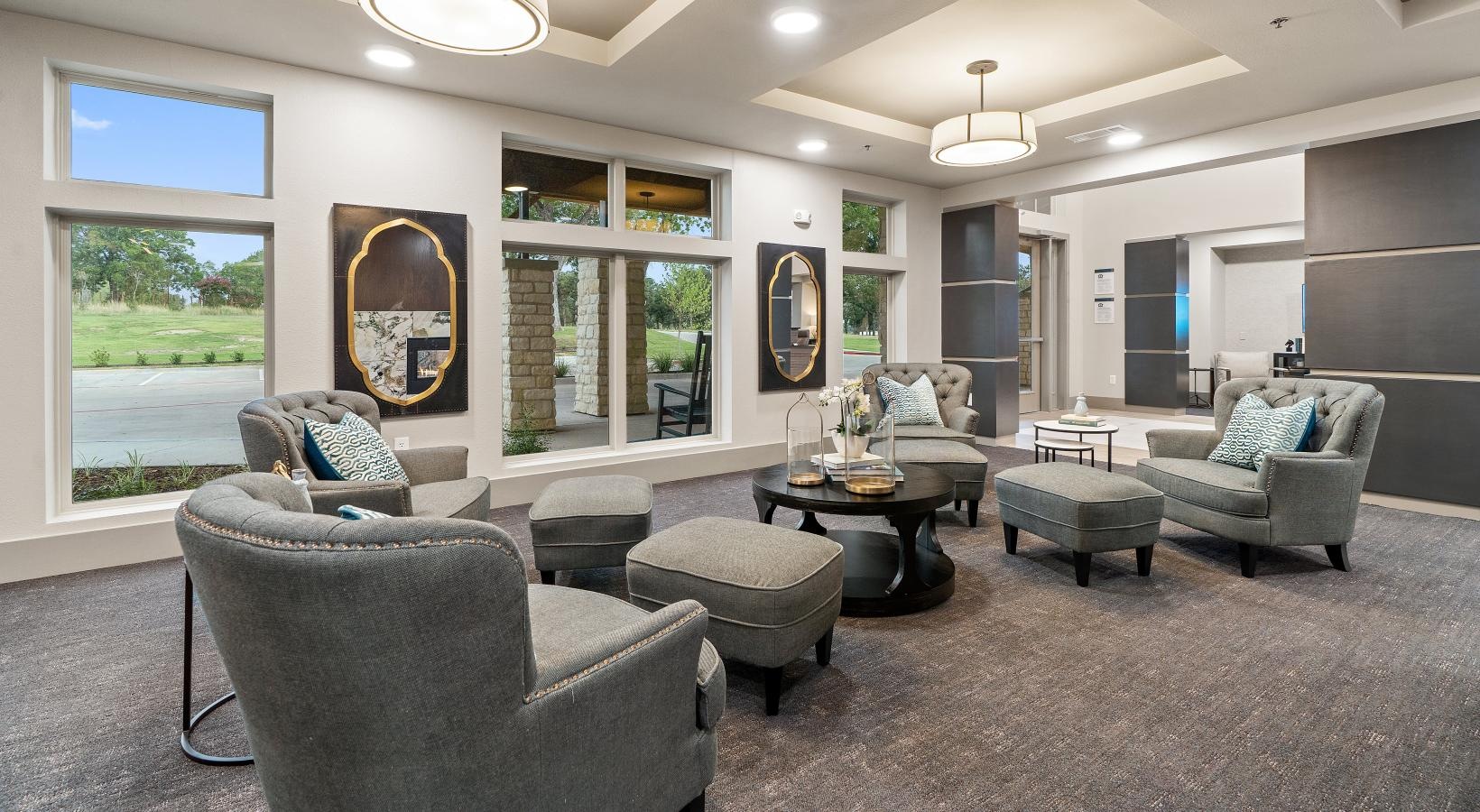 The essence of exceptional living a lounge room with a cushy seating and a large window