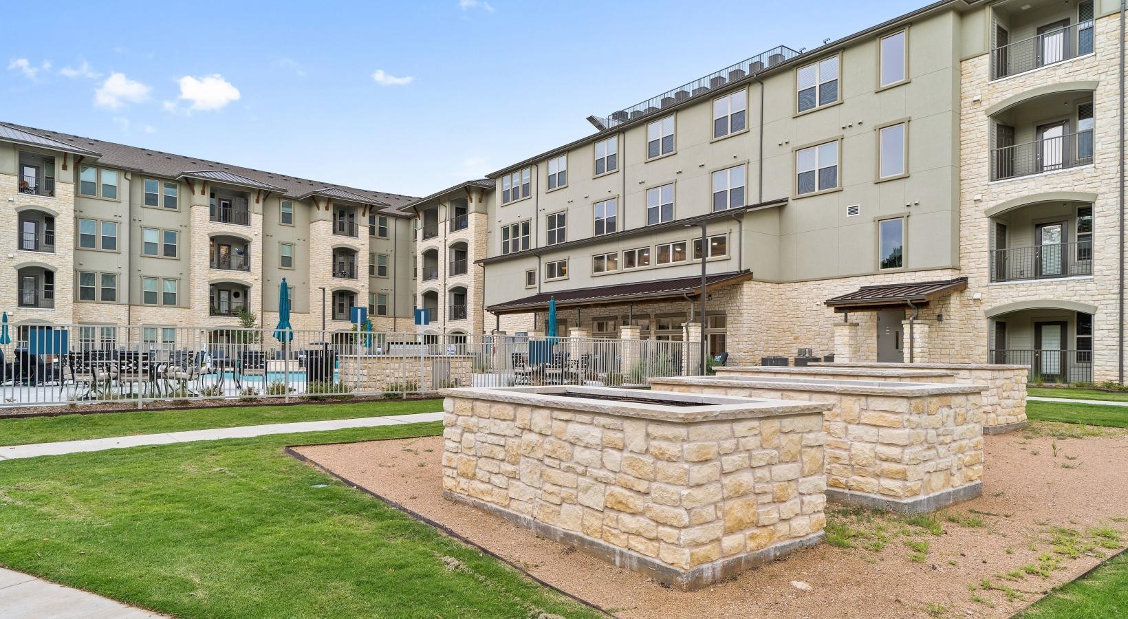The essence of exceptional living a stone firepit in front of a building