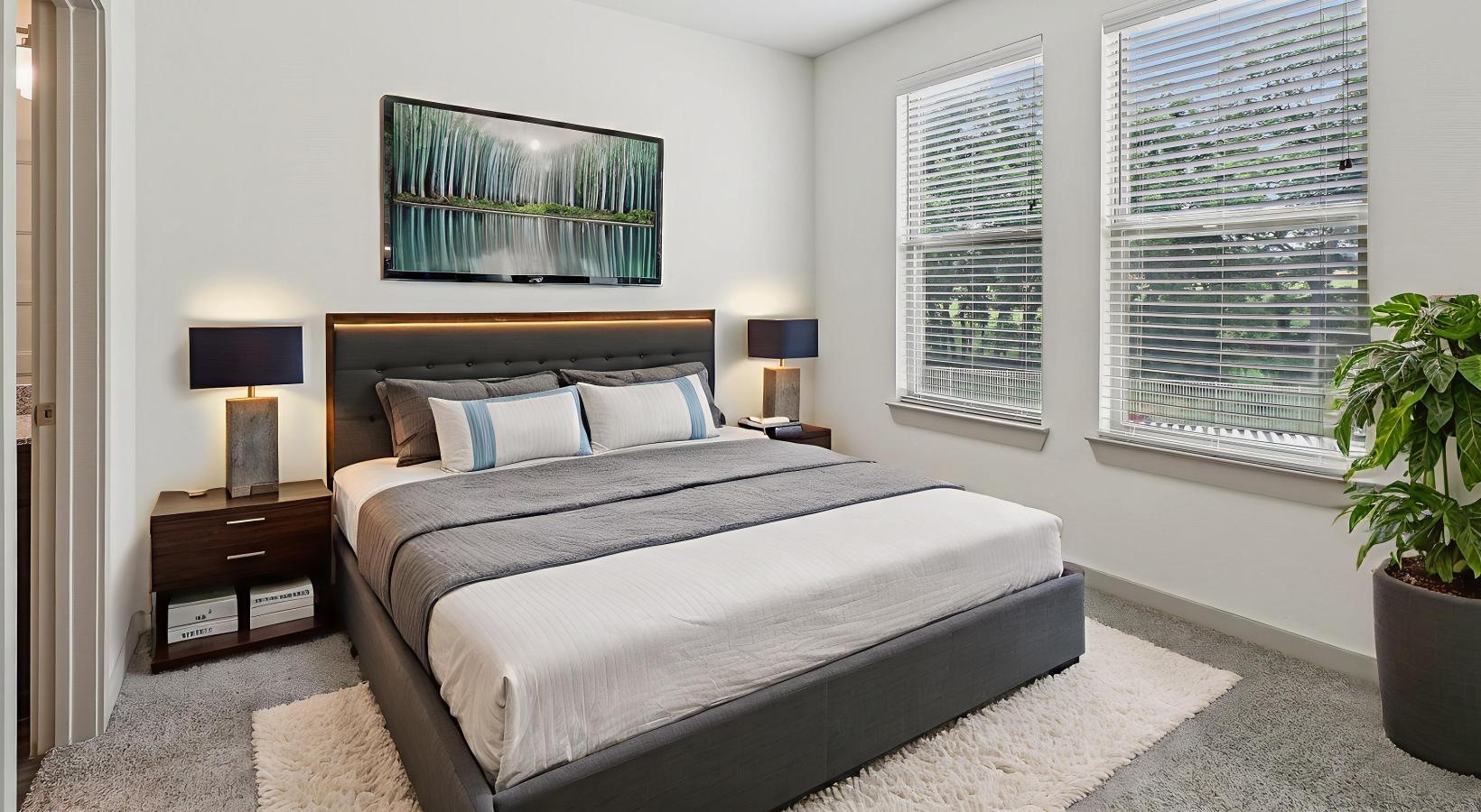 Beautiful bedrooms to fit every need a bedroom with a bed and lamps and windows