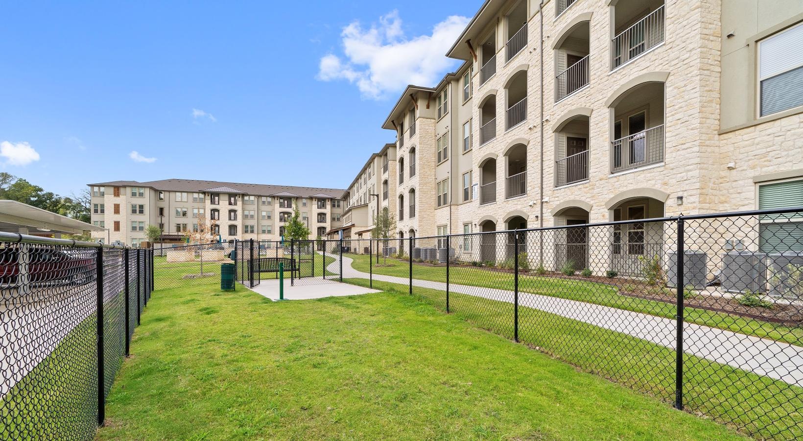 Find your perfect fit at Preserve at Willow Park a fenced in lawn in front of a building