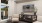 a lounge room with seating a tv and a window