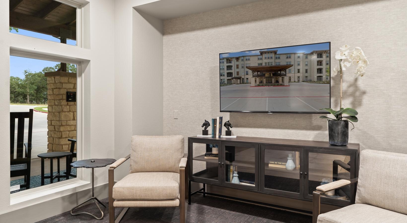 The essence of exceptional living a lounge room with seating a tv and a window