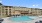 a large building with a pool in front of it