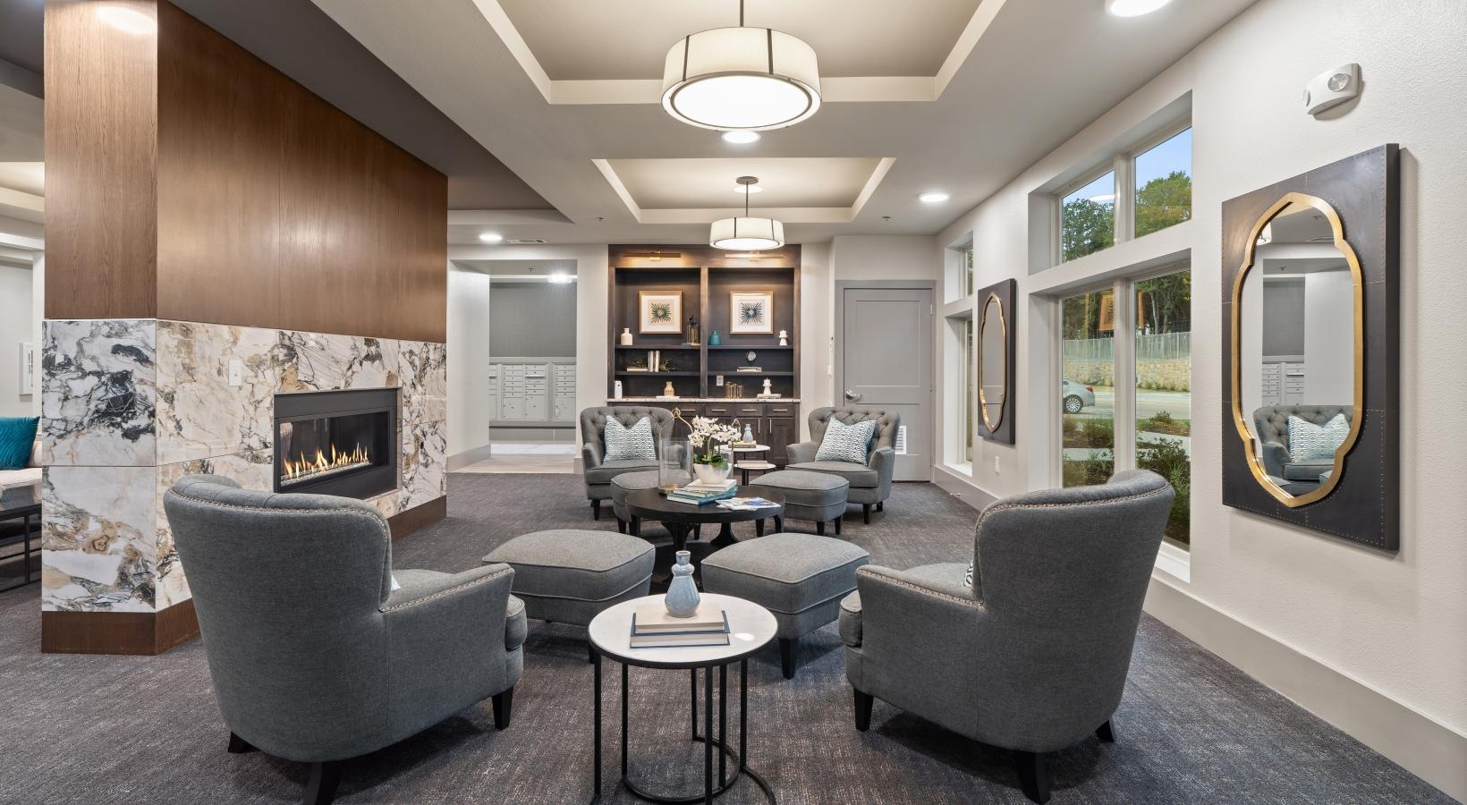 Settle into comfort at Preserve at Willow Park a lounge room with a fireplace and seating with side tables
